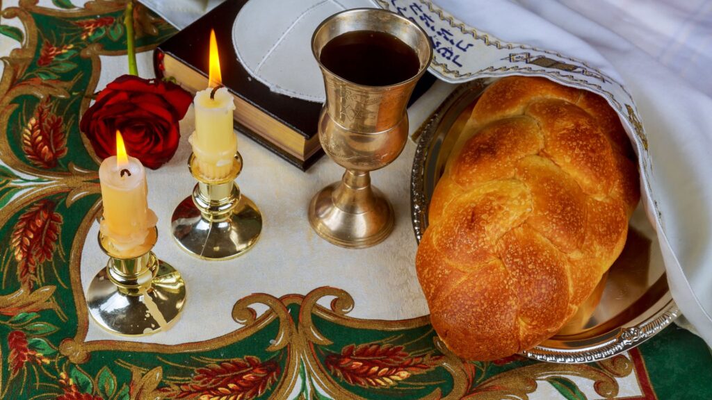 kosher-food-shabbat-table.jpg (1200 × 630px) · Alt: Traditional Shabbat table with kosher food — challah, candlesticks, kiddush cup